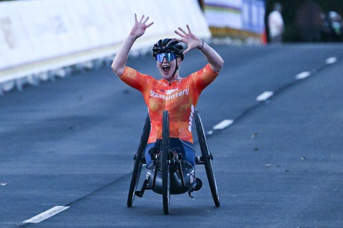 A female tricyclist raises her hands in surprise